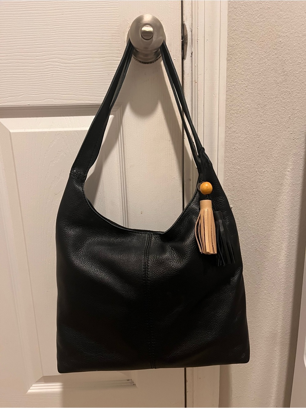 The Sak Black Leather Shoulder Hobo with Beige Tassel